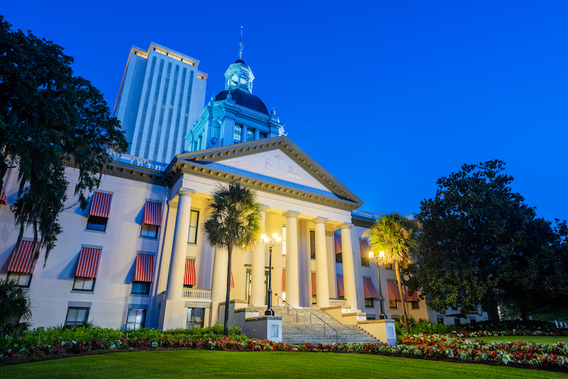 Tallahassee, Florida, USA with the Old and New Capitol Building at twilight.